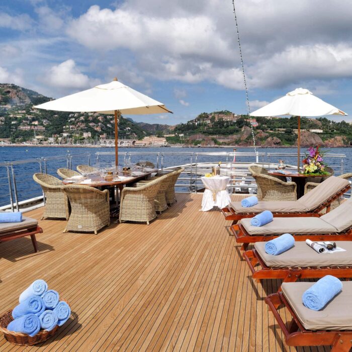 Christina O superyacht charter sunbeds