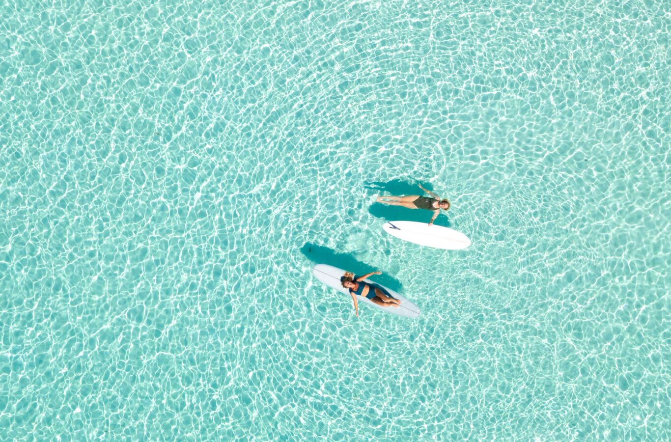two people on a paddle board in the indian ocean