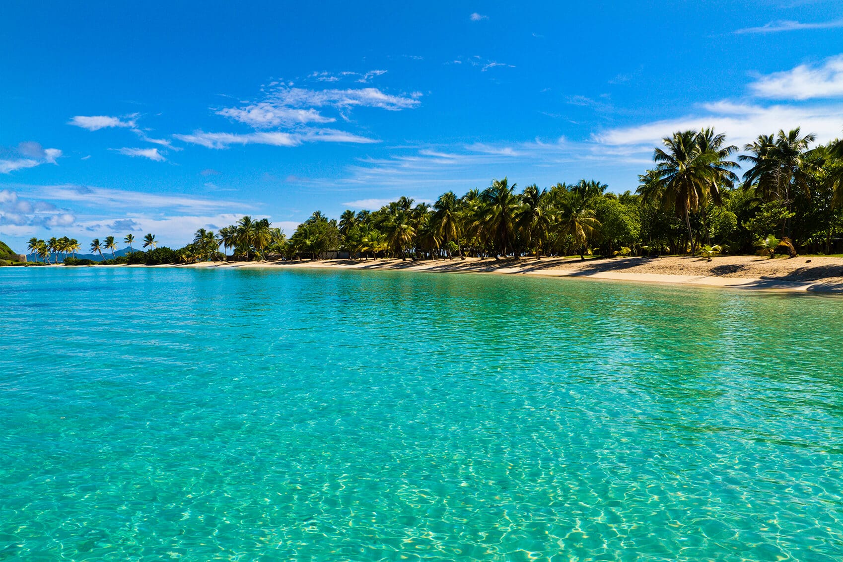 Salt Whistle Bay is one of the most famous and photographed beaches of the Grenadines, one and a half mile of white sand lapped by crystal clear and calm waters. It is located on Mayreau Island, that is one of the smaller Grenadines and lies north-west of the famous Tobago Cays. St. Vincent and the Grenadines.