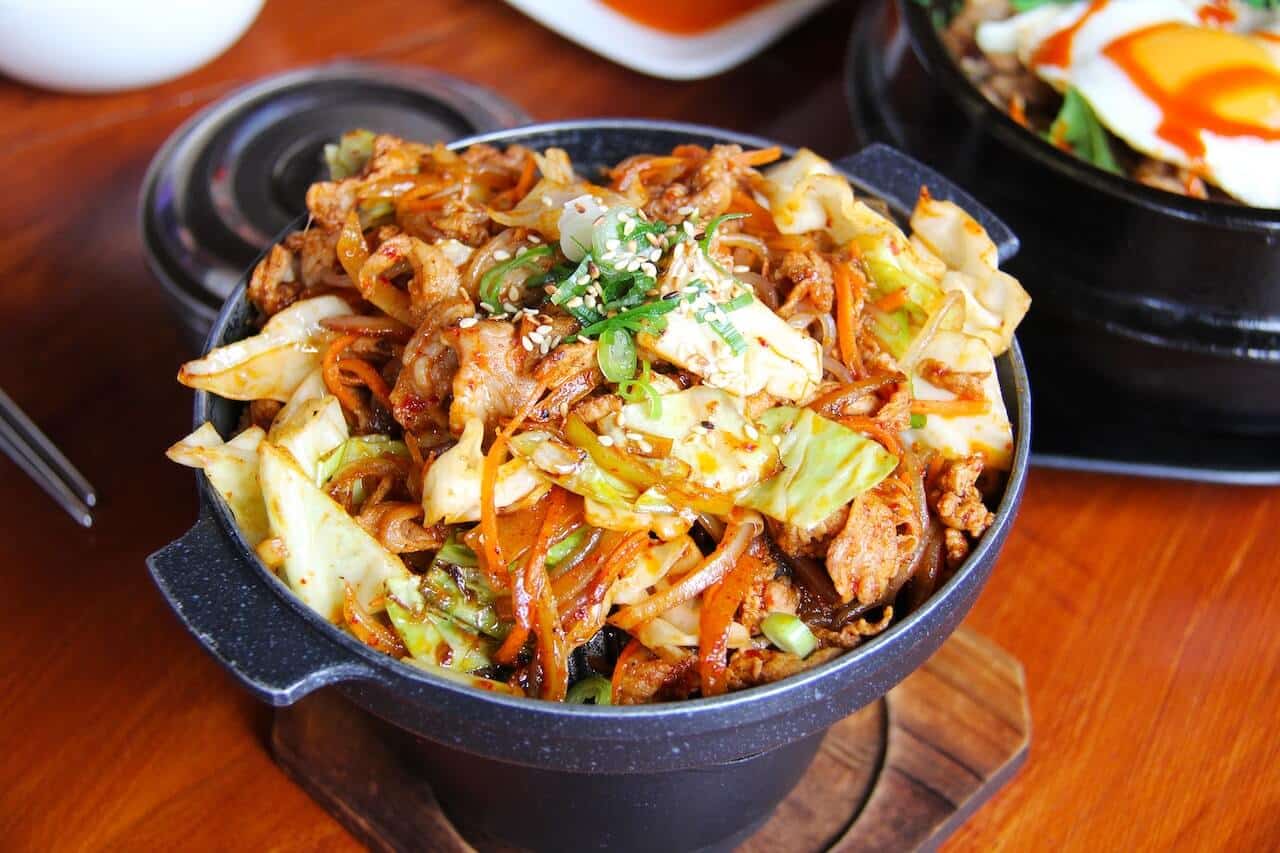 a hot pot full of fresh thai ingredients