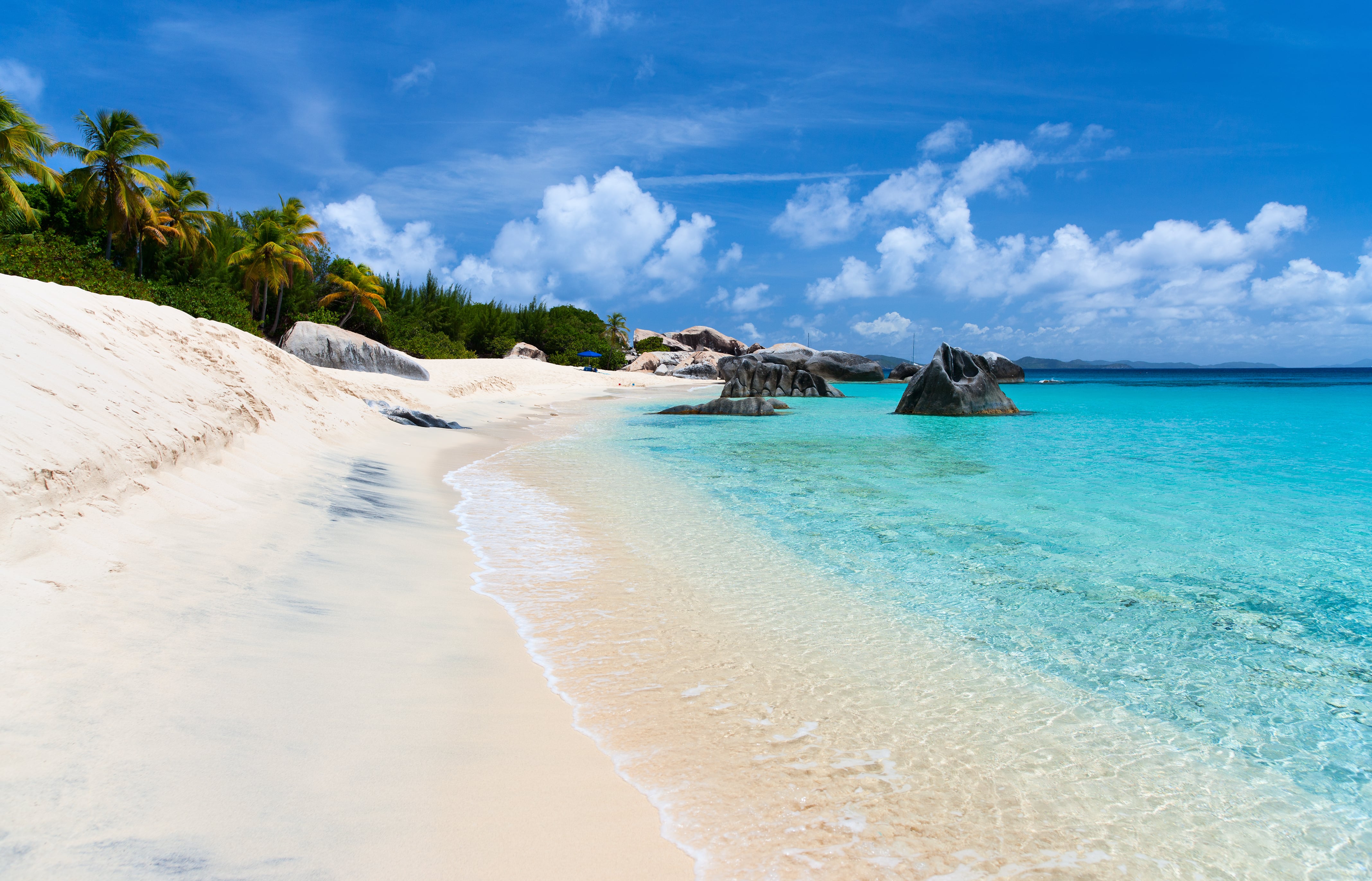 Beautiful tropical beach with white sand, turquoise ocean water and blue sky at Virgin Gorda, British Virgin Islands in Caribbean