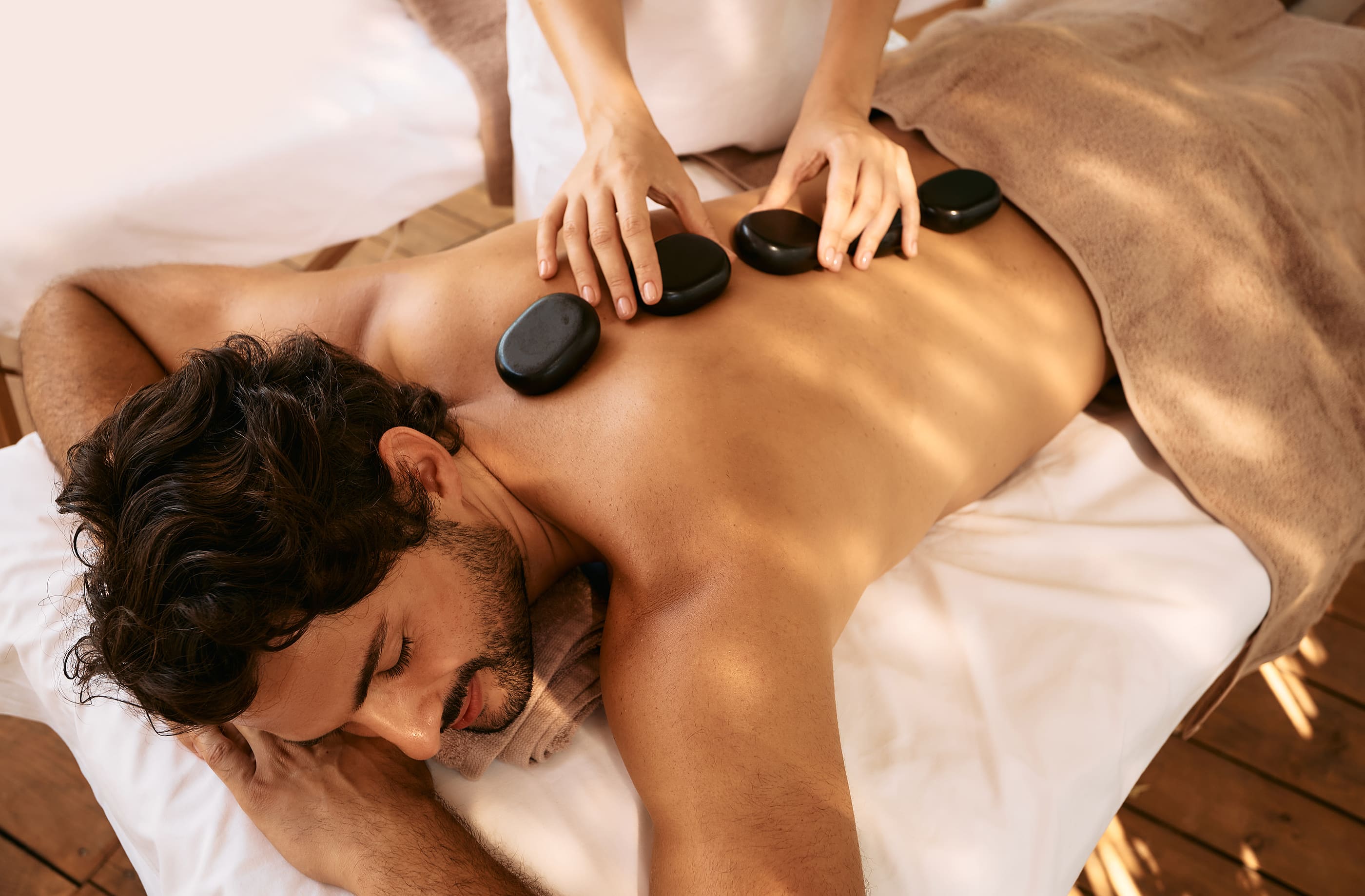 Hot stone massage therapy using smooth, flat, heated stones