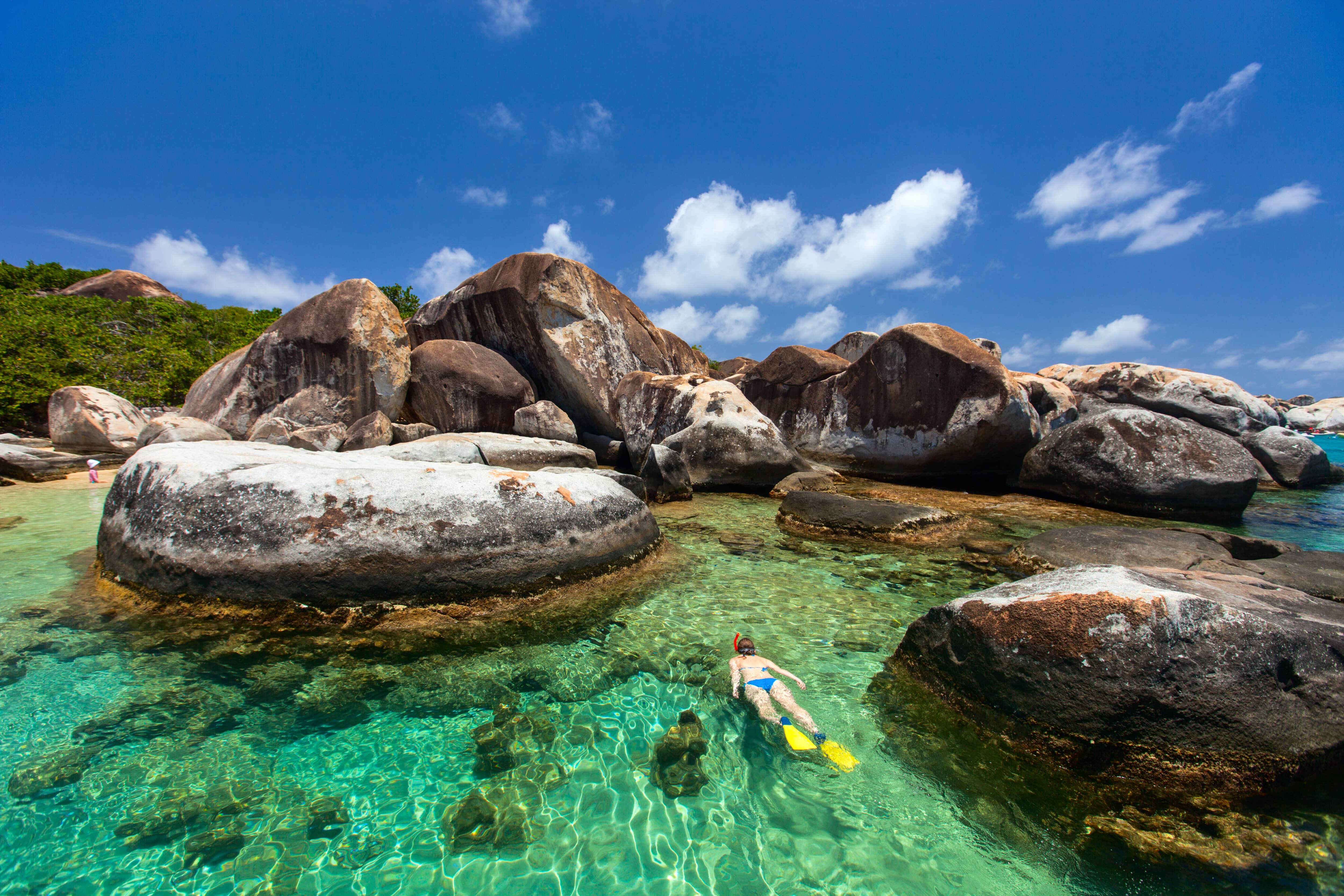 snorkeling in turquoise tropical water among huge granite boulders at The Baths beach area major tourist attraction on Virgin Gorda, British Virgin Islands, Caribbean