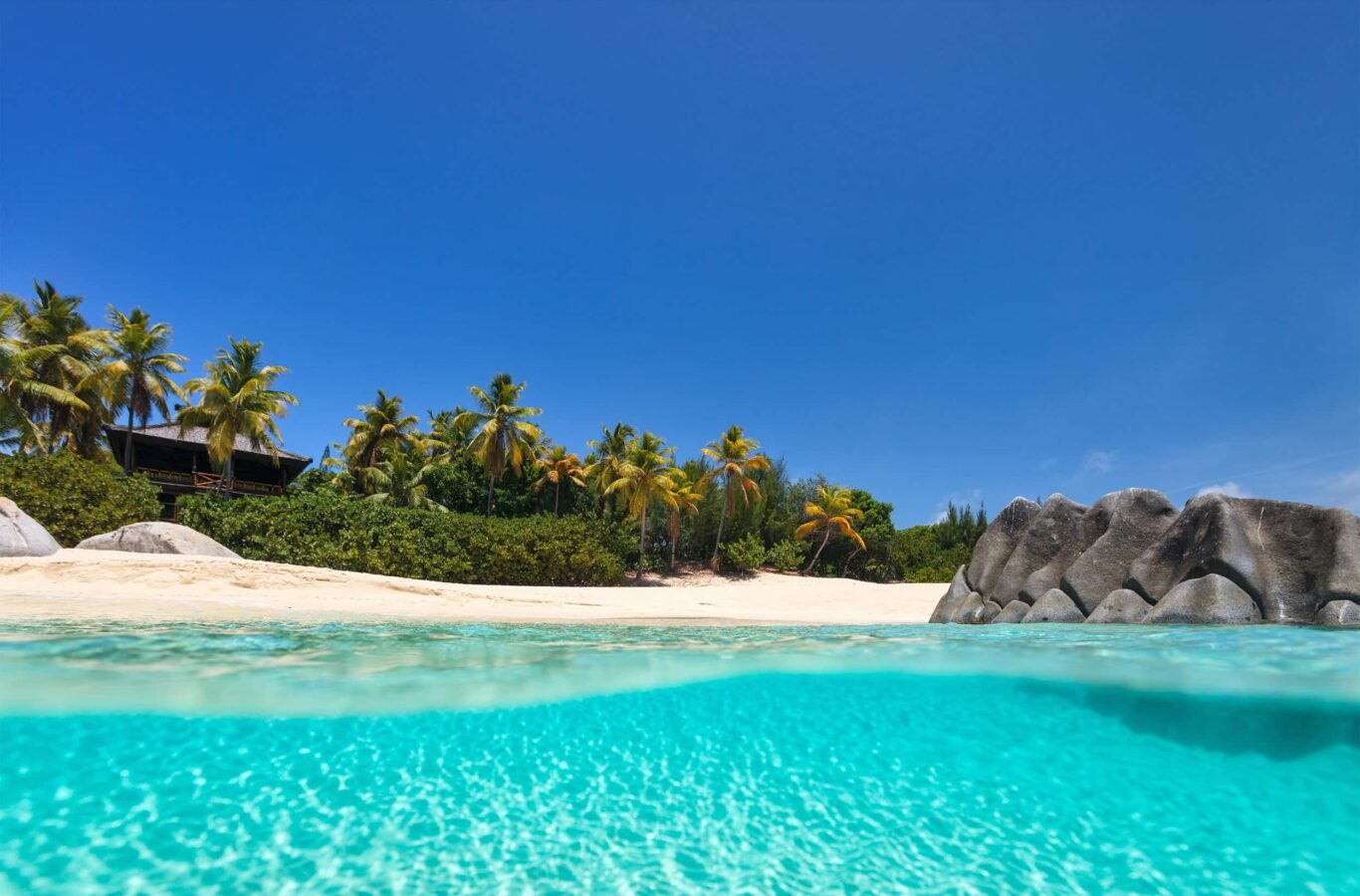 beach with white sand, turquoise ocean water and blue sky at Virgin Gorda, British Virgin Islands superyacht charter in Caribbean