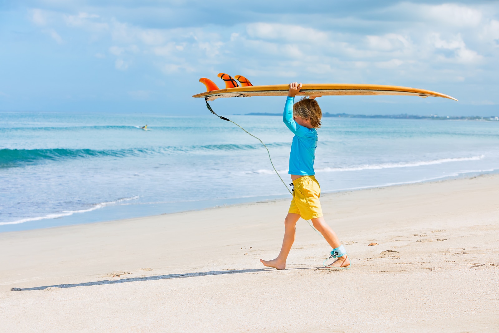 young surfer about to ride on a surfboard