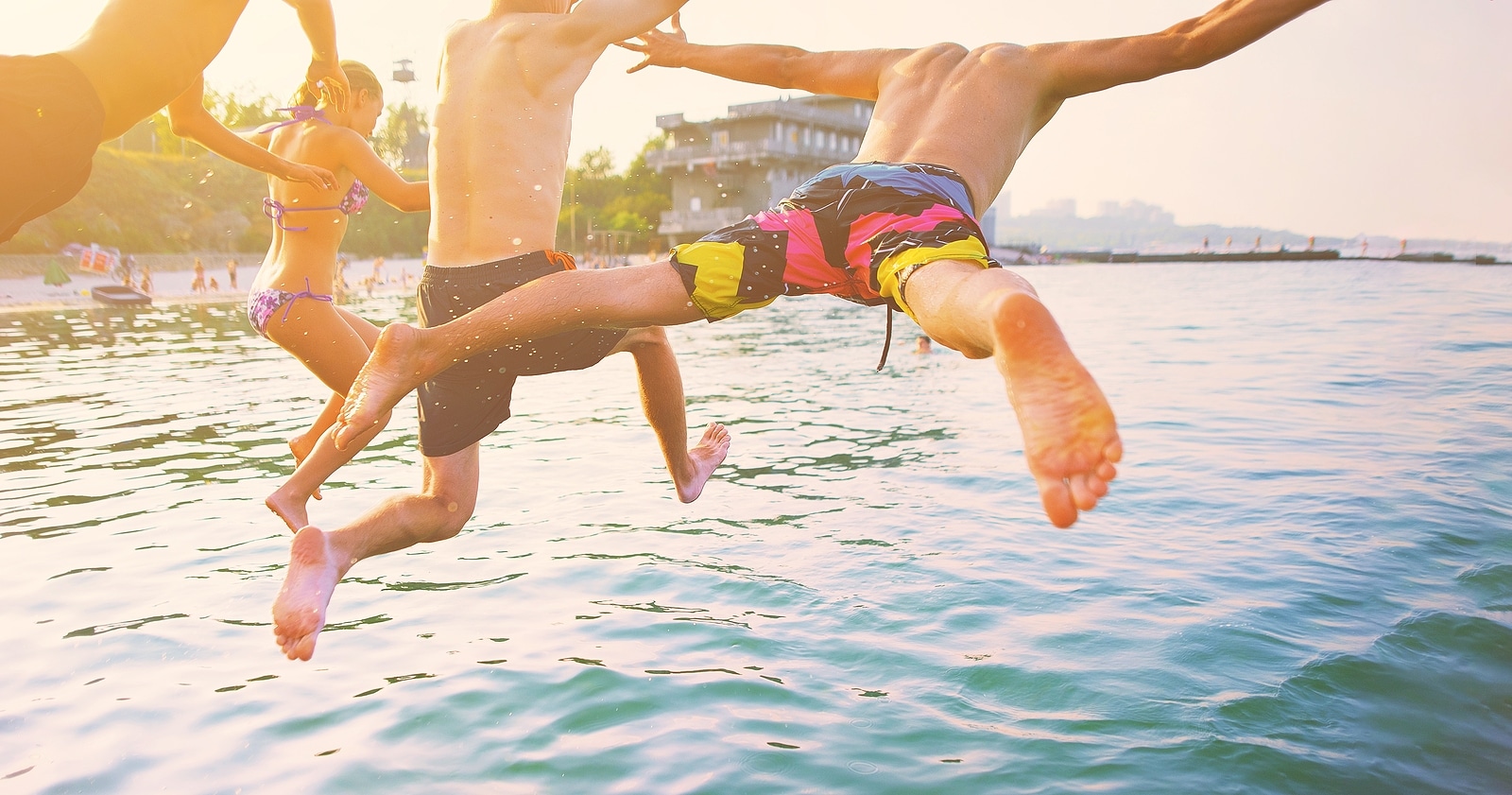 Group of people having fun jumping in the sea