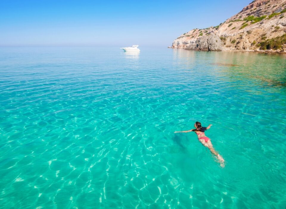woman swimming in the seychelles turquoise water